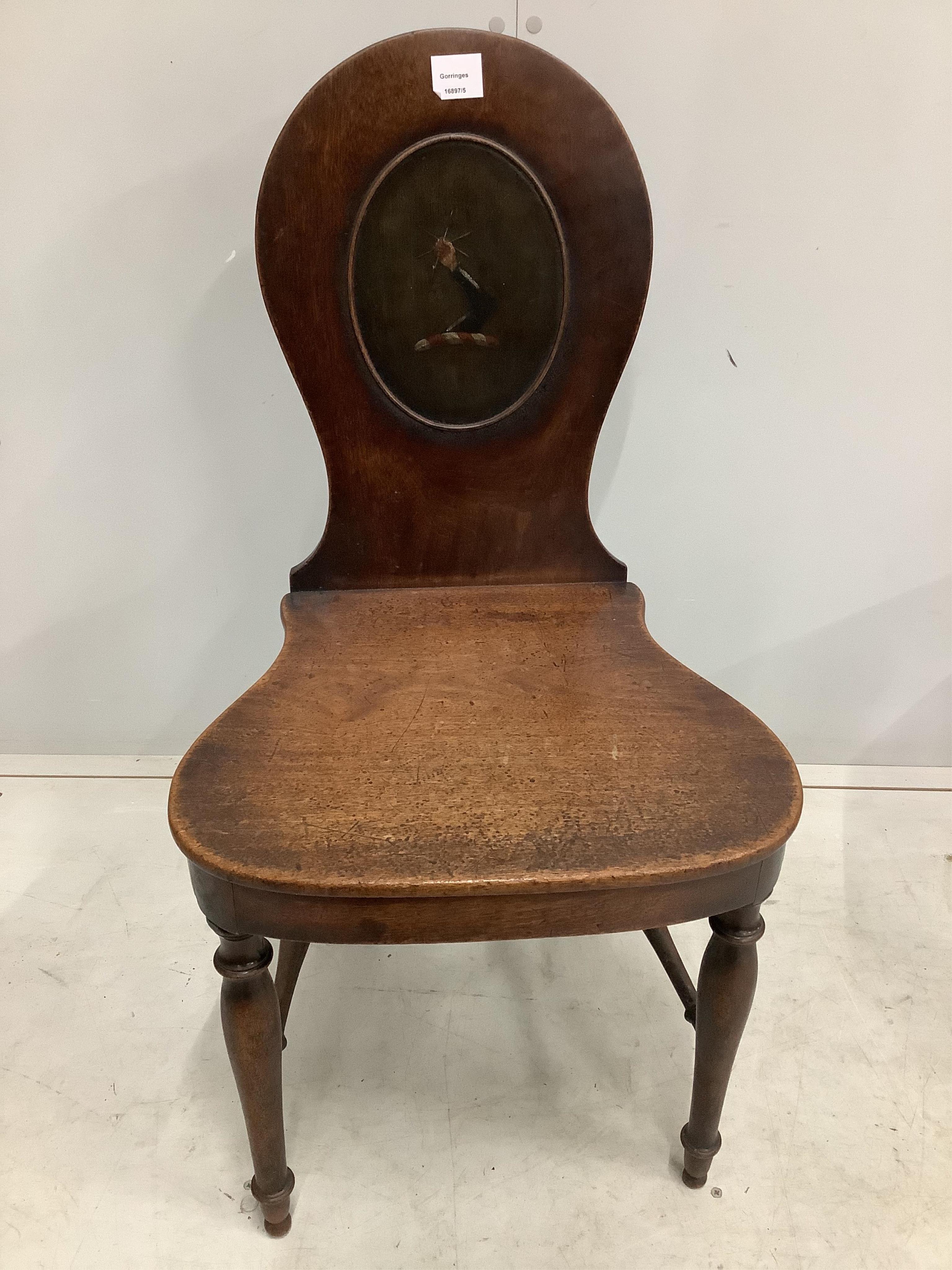 A pair of George III mahogany hall chairs with painted armorials, width 47cm, depth 42cm, height 92cm. Condition - fair